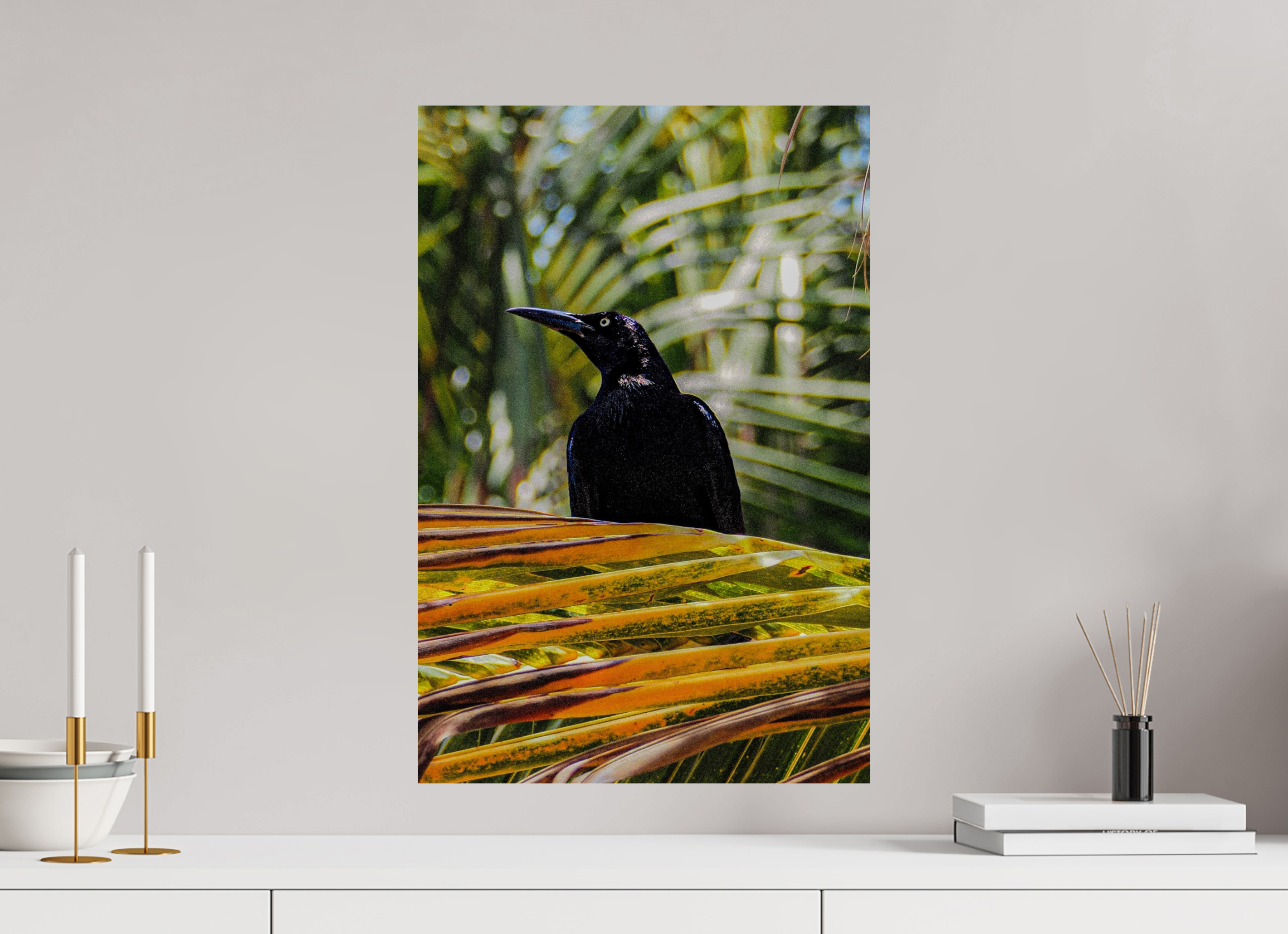 Black bird on a palm leaf with a minimalistic decor setting