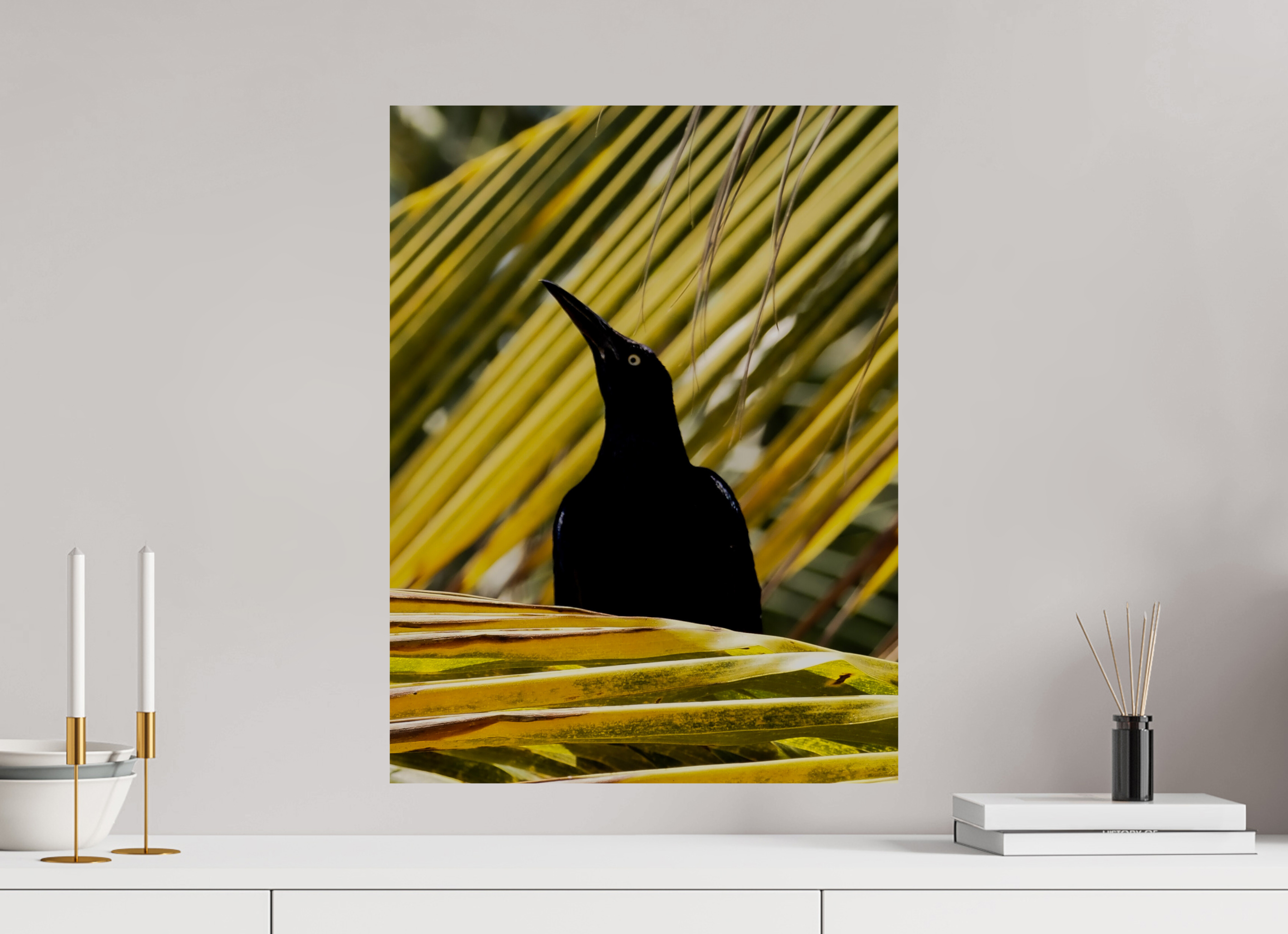 Canvas print of a black bird silhouette on yellow leaves against a gray wall.