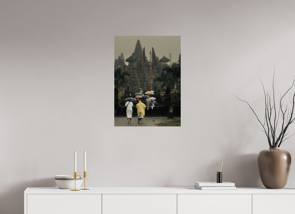 Art print of a rainy street scene with people holding umbrellas on a wall above a white cabinet.