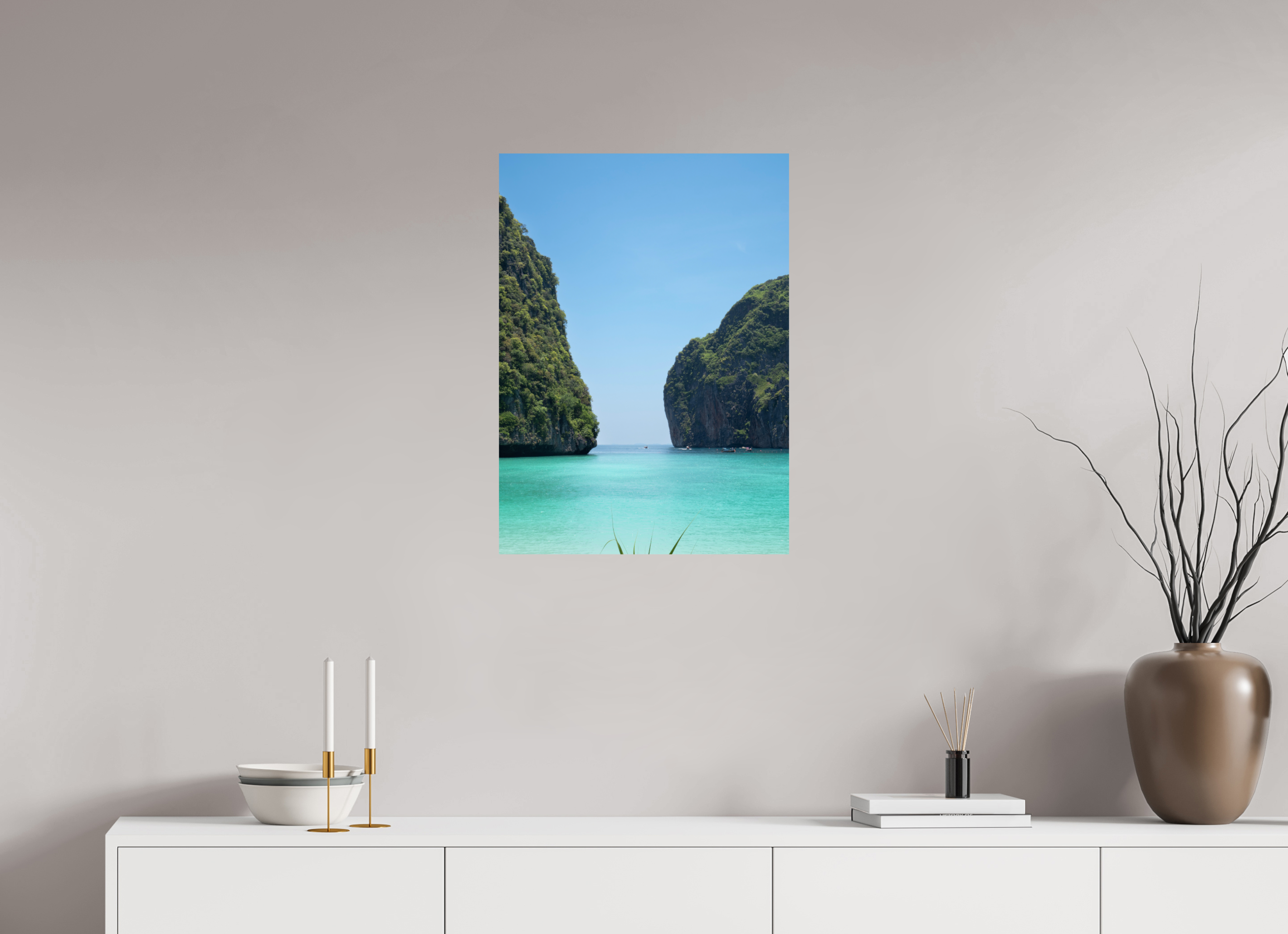 Canvas print of a tropical island scene on a wall above a white console table.