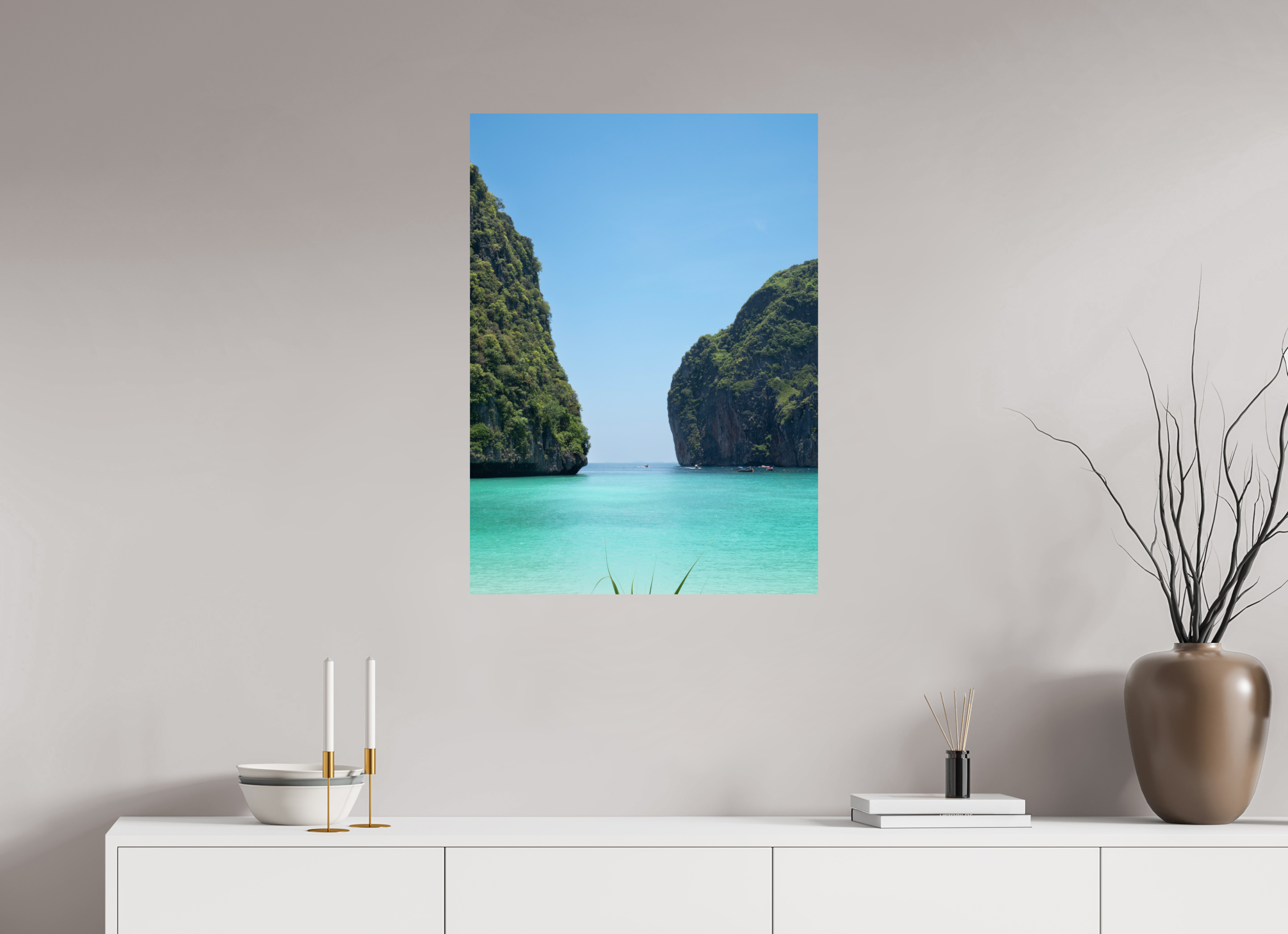 Canvas print of a tropical island scene on a wall above a white console table.
