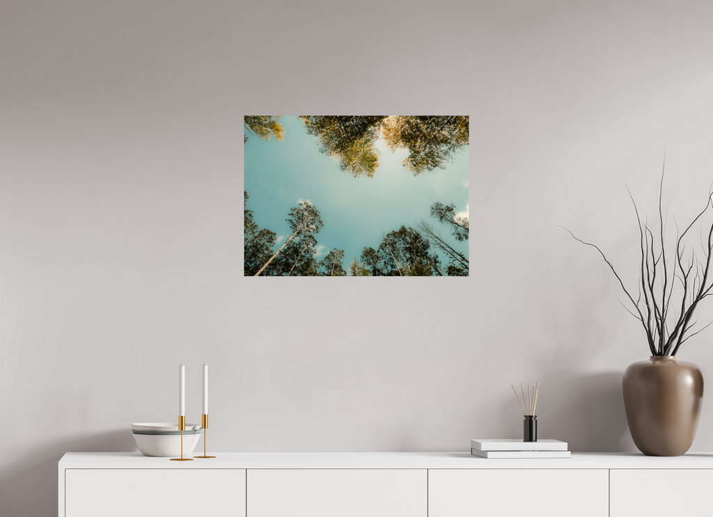 Wall art of trees against a blue sky in a modern interior setting.