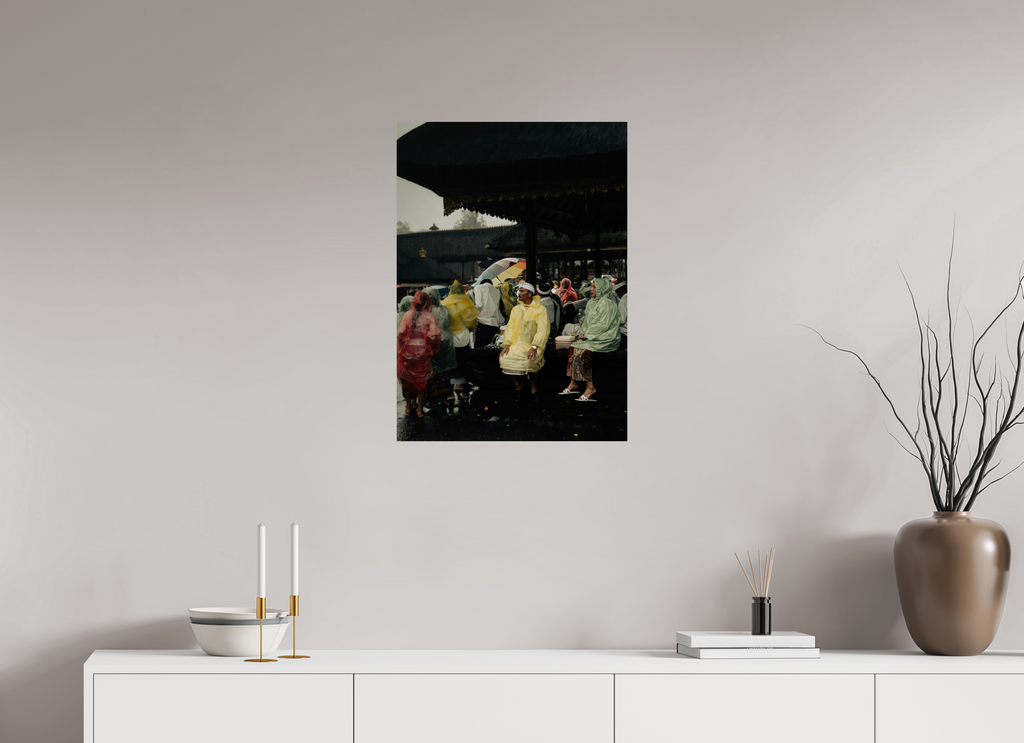 Framed artwork of a rainy street scene on a wall above a white console table.