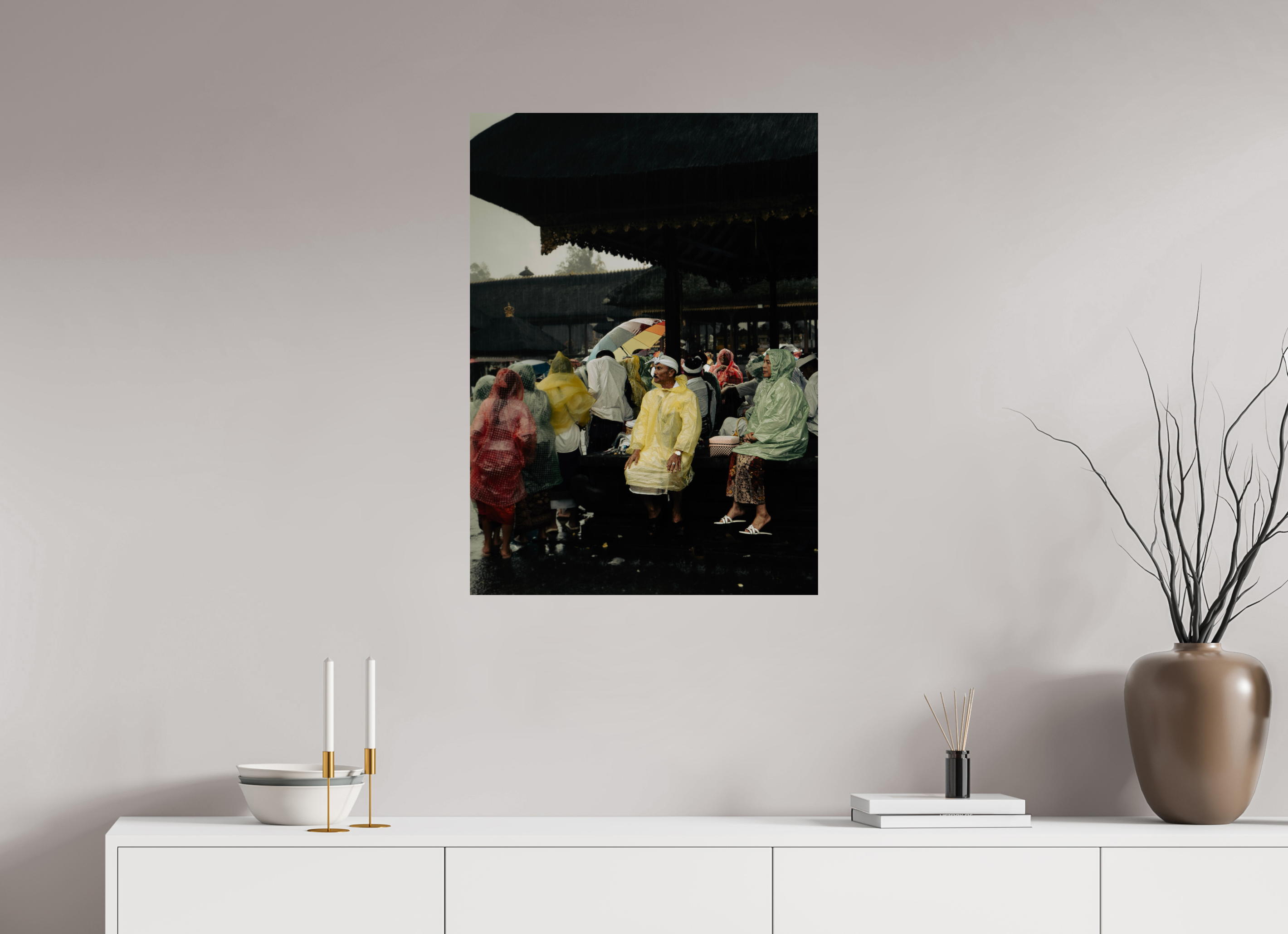Framed artwork of a rainy street scene on a wall above a white console table.